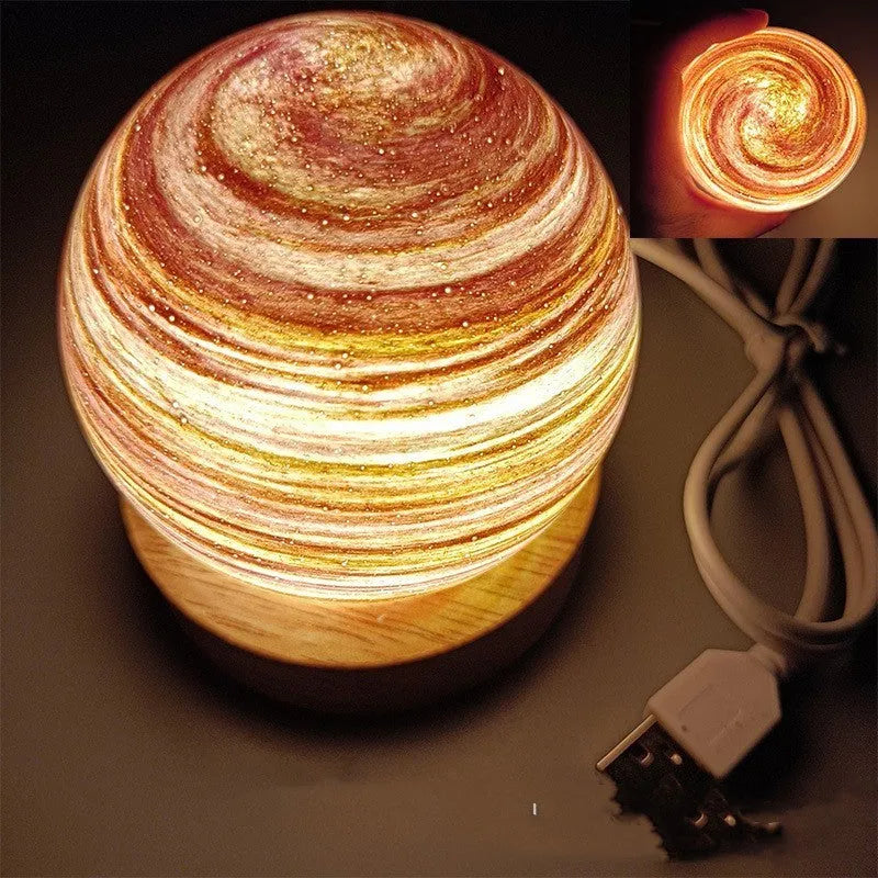 Planet-shaped USB night light with adjustable dimming in 12 colour options on its base.