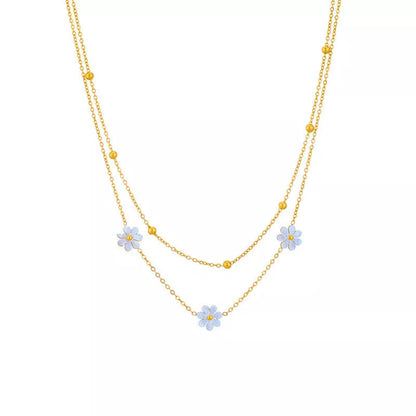 Stainless steel daisy flower jewelry set with necklace, bracelet, and earrings in electroplated gold finish