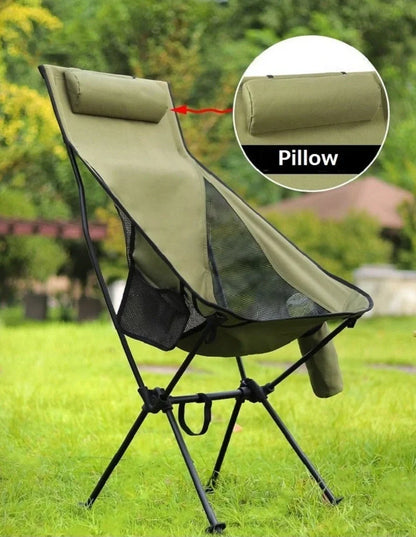 Army green outdoor folding chair with adjustable backrest and legs in reclined position on grass