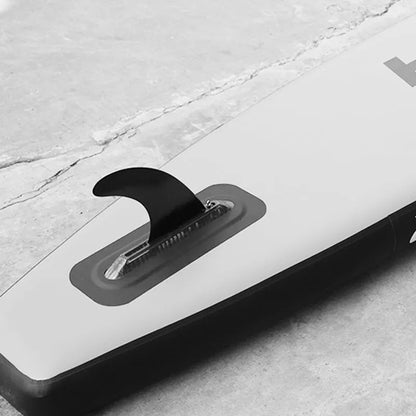 SUP paddle with detachable fish fins showing screw attachment system and plastic construction