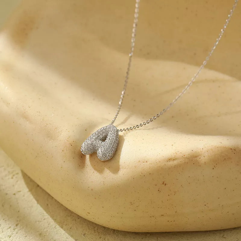 Stainless steel initial pendant necklace with zircon accents, personalized with your choice of letter.