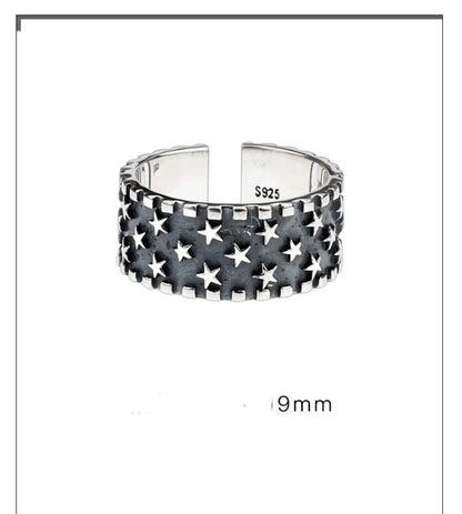 Close-up of a polished sterling silver ring with a raised five-pointed star pattern on an adjustable band.