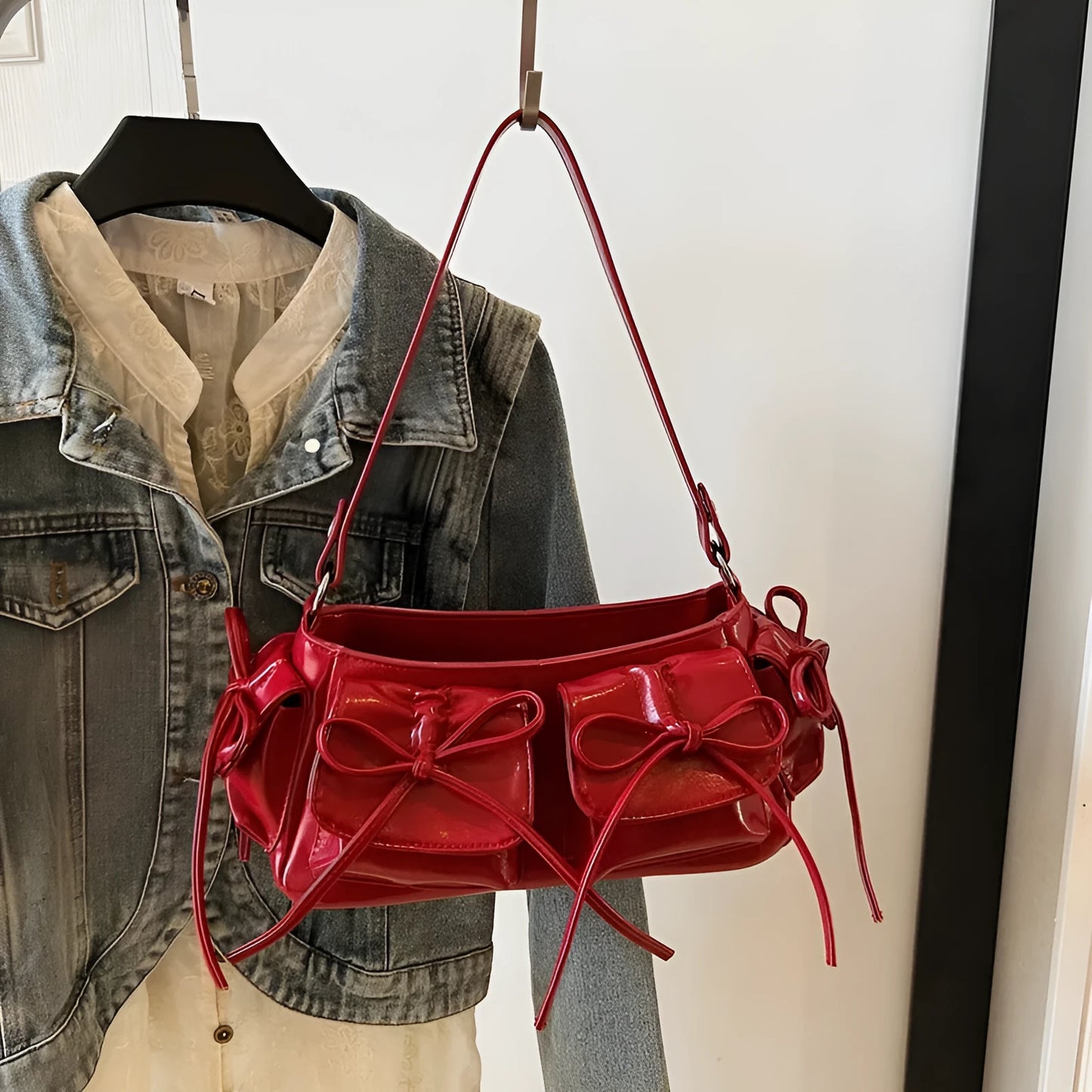 Women's tassel bow shoulder bag in pleated design with multiple pockets, shown in a selected colour.