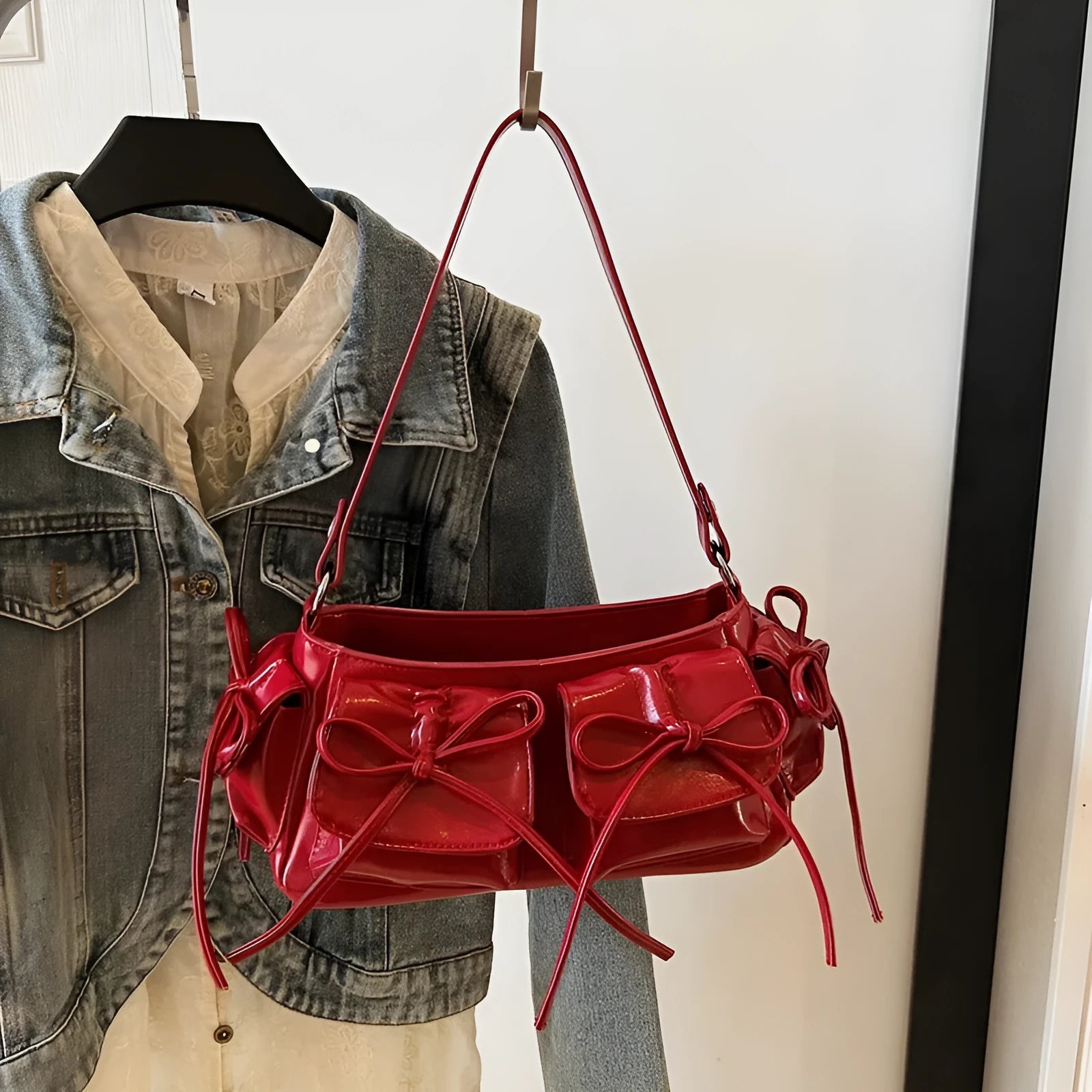 Women's tassel bow shoulder bag in pleated design with multiple pockets, shown in a selected colour.