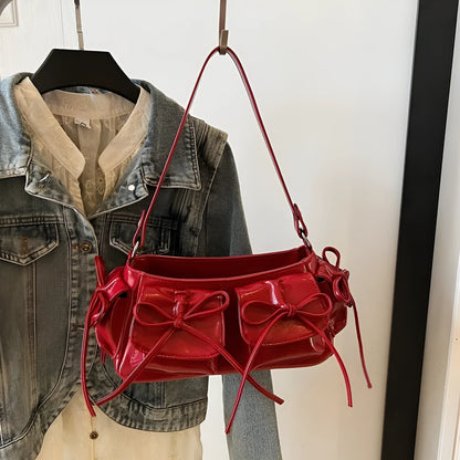Women's tassel bow shoulder bag in pleated design with multiple pockets, shown in a selected colour.