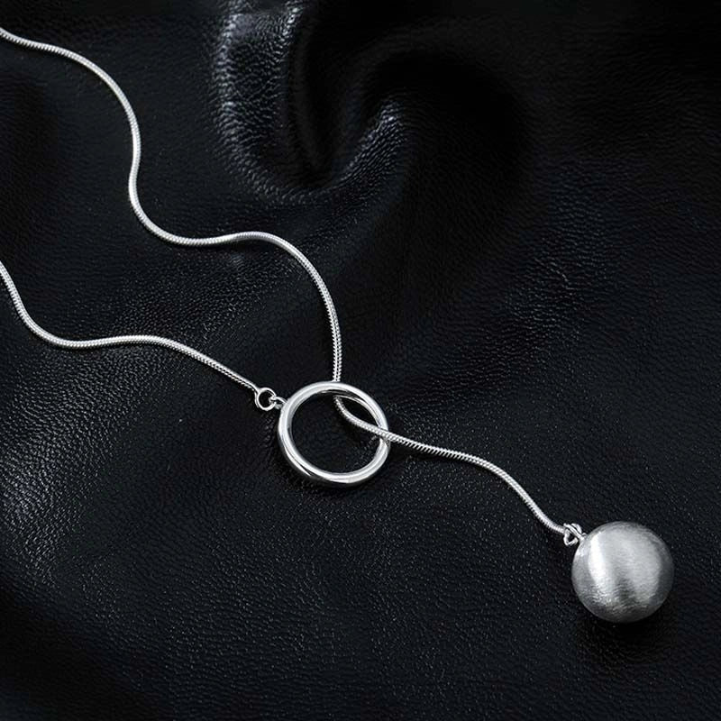 Elegant platinum plated ball necklace with a sleek snake bone chain, perfect for fashionable fall and winter accessorizing