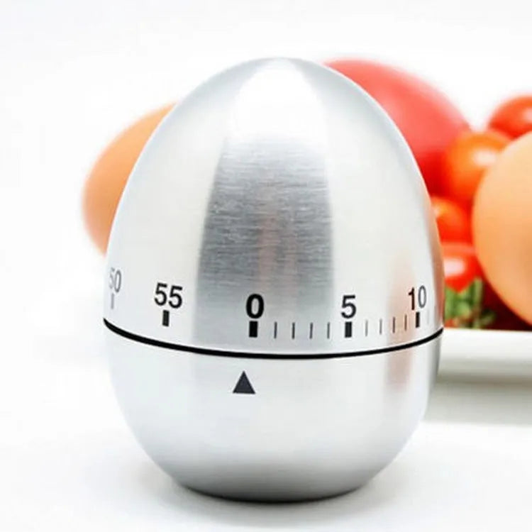 Stainless steel mechanical kitchen timer with egg-shaped design on kitchen counter