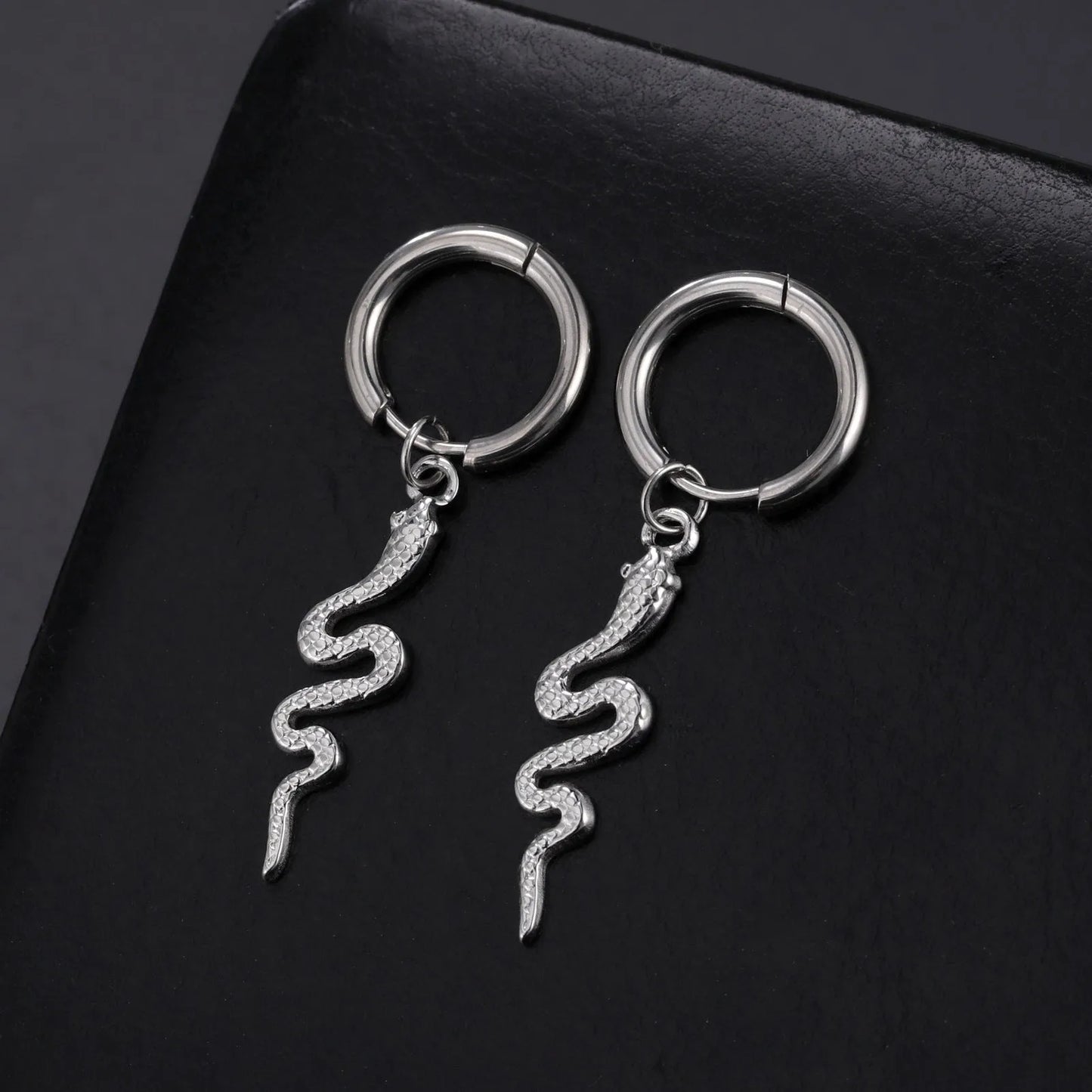 Gold coloured snake-shaped vintage clip-on earrings made from stainless steel.