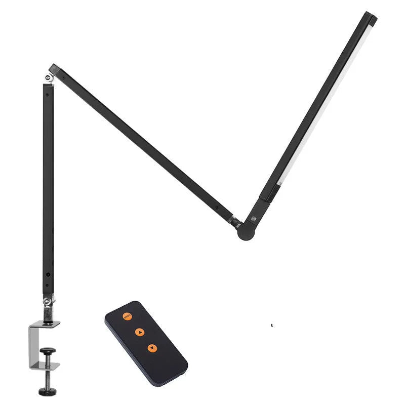 Clip-on adjustable arm LED desk lamp in black mounted on a desk edge with remote control.