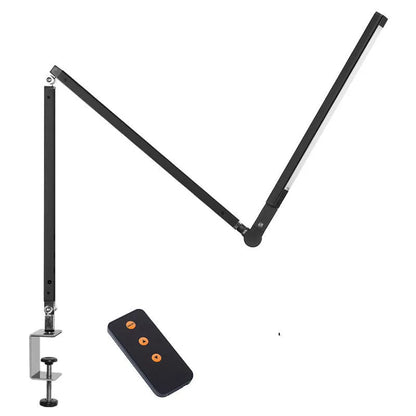 Clip-on adjustable arm LED desk lamp in black mounted on a desk edge with remote control.