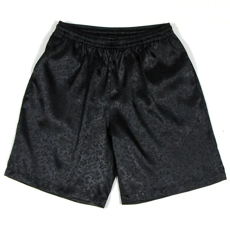 Men's black Tai Chi shorts with a white drawstring elastic waistband laid flat.