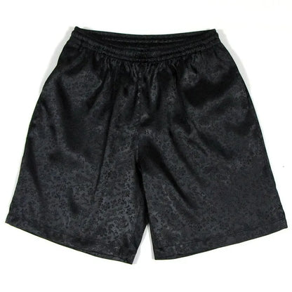 Men's black Tai Chi shorts with a white drawstring elastic waistband laid flat.