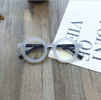 Retro round frame anti blue light glasses in various colours on a plain background