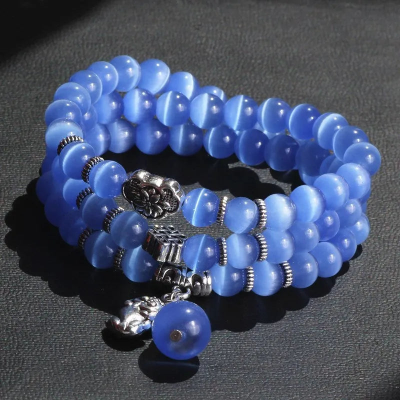 Women's opal crystal bracelet with lucky cat charm and geometric design, shown in blue colour option