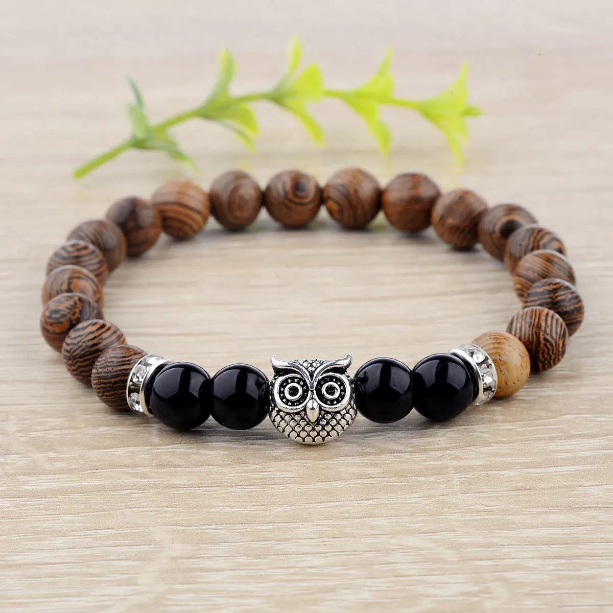 Owl frosted stone lifeline wood grain bracelet in black and gold, featuring wood beads and alloy stone