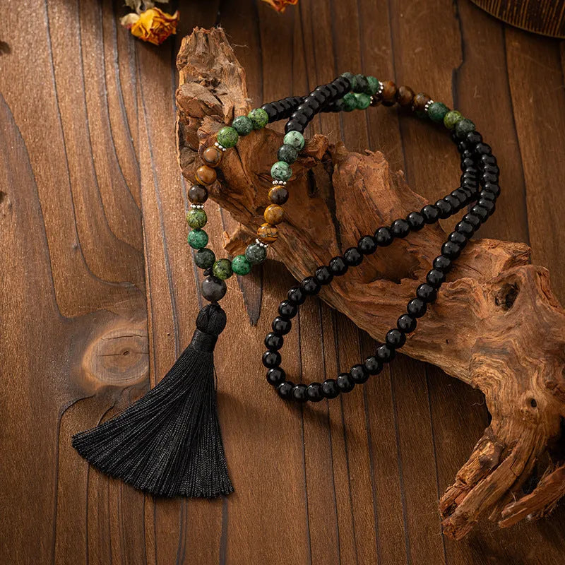 Vintage bohemian-style long beaded sweater chain with a tassel, showing necklace and bracelet lengths.