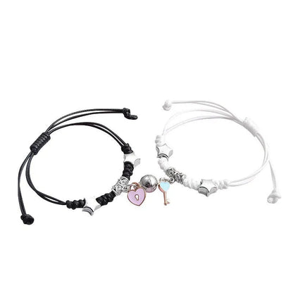 Magnetic suction couple bracelet pair in alloy with an electroplated finish, showing example designs like a crown and love lock.