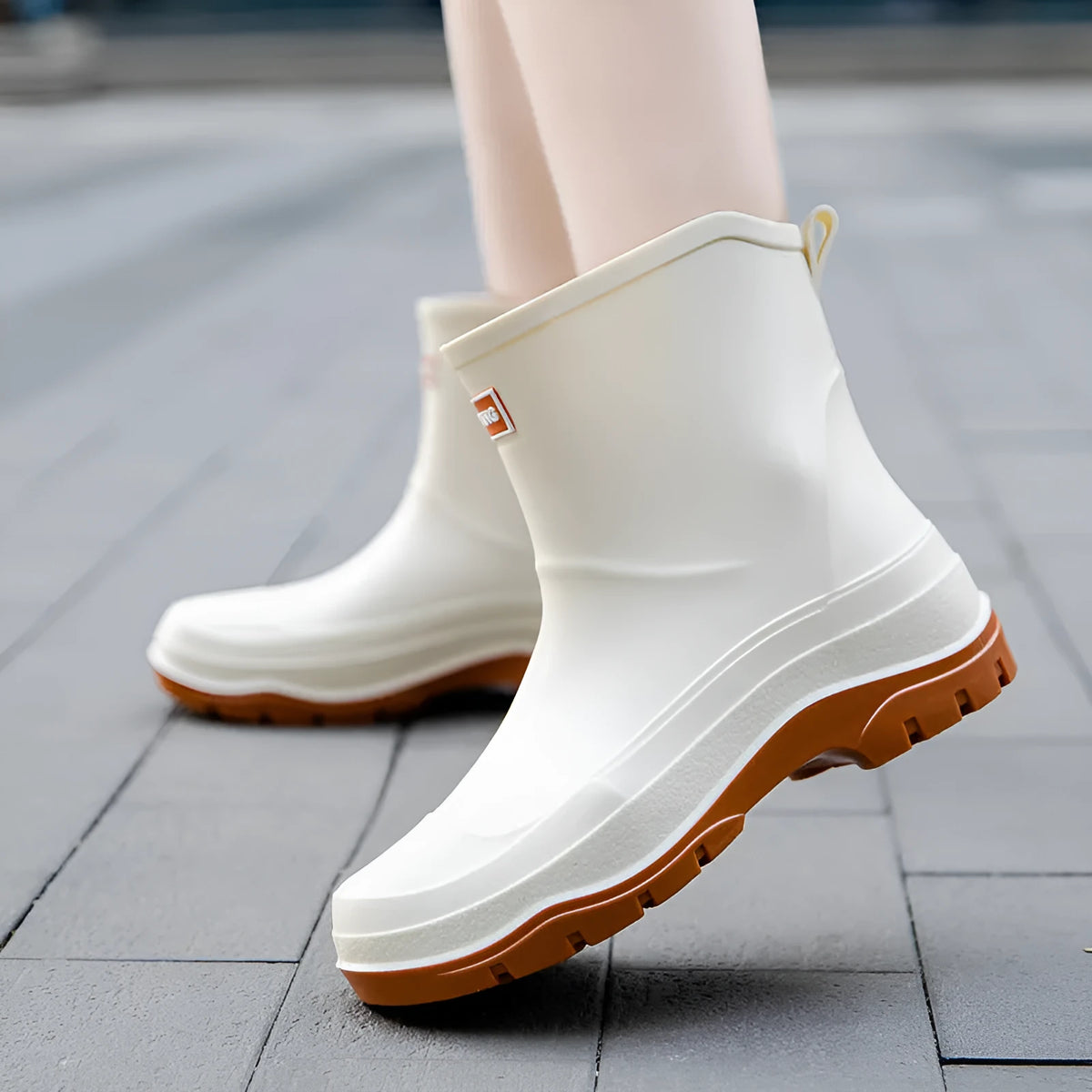 Women's low-cut white waterproof plastic shoes with a non-slip rubber sole on a plain background.