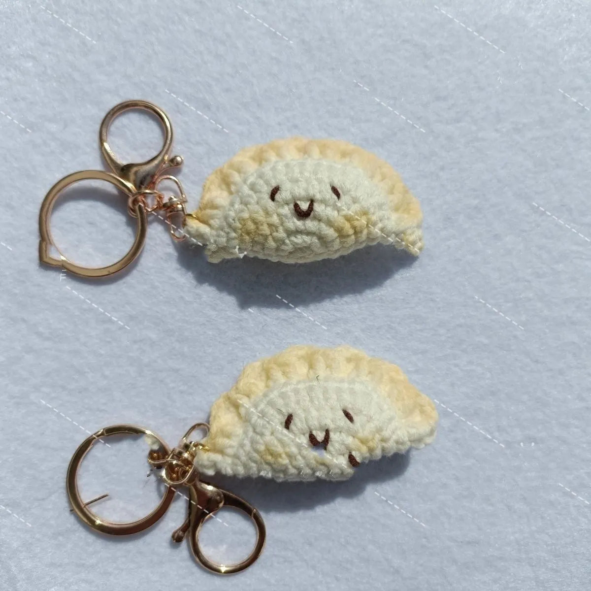 Handmade crochet dumpling pendant with keychain showing plush texture and hand-stitched decorative eyes