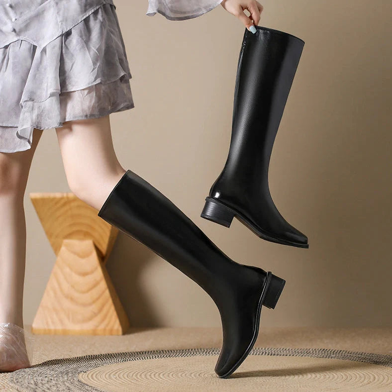 Black square toe over-the-knee boots with 4cm chunky heel showing leather interior and rubber sole