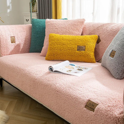 Beige lamb wool plush sofa cover with anti-slip backing on a grey fabric sofa.