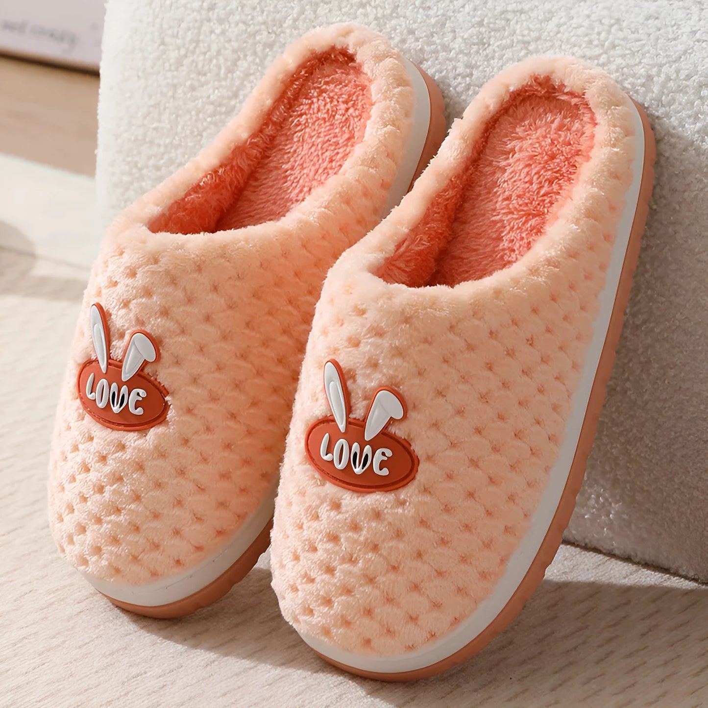Women's plush rabbit plaid design winter slippers with a thick light-coloured rubber sole.