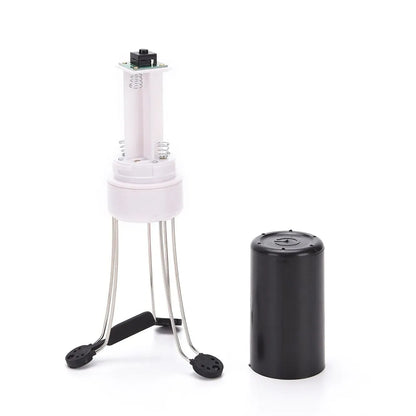 White and black wireless automatic kitchen stirrer with three-speed button, shown next to a saucepan.