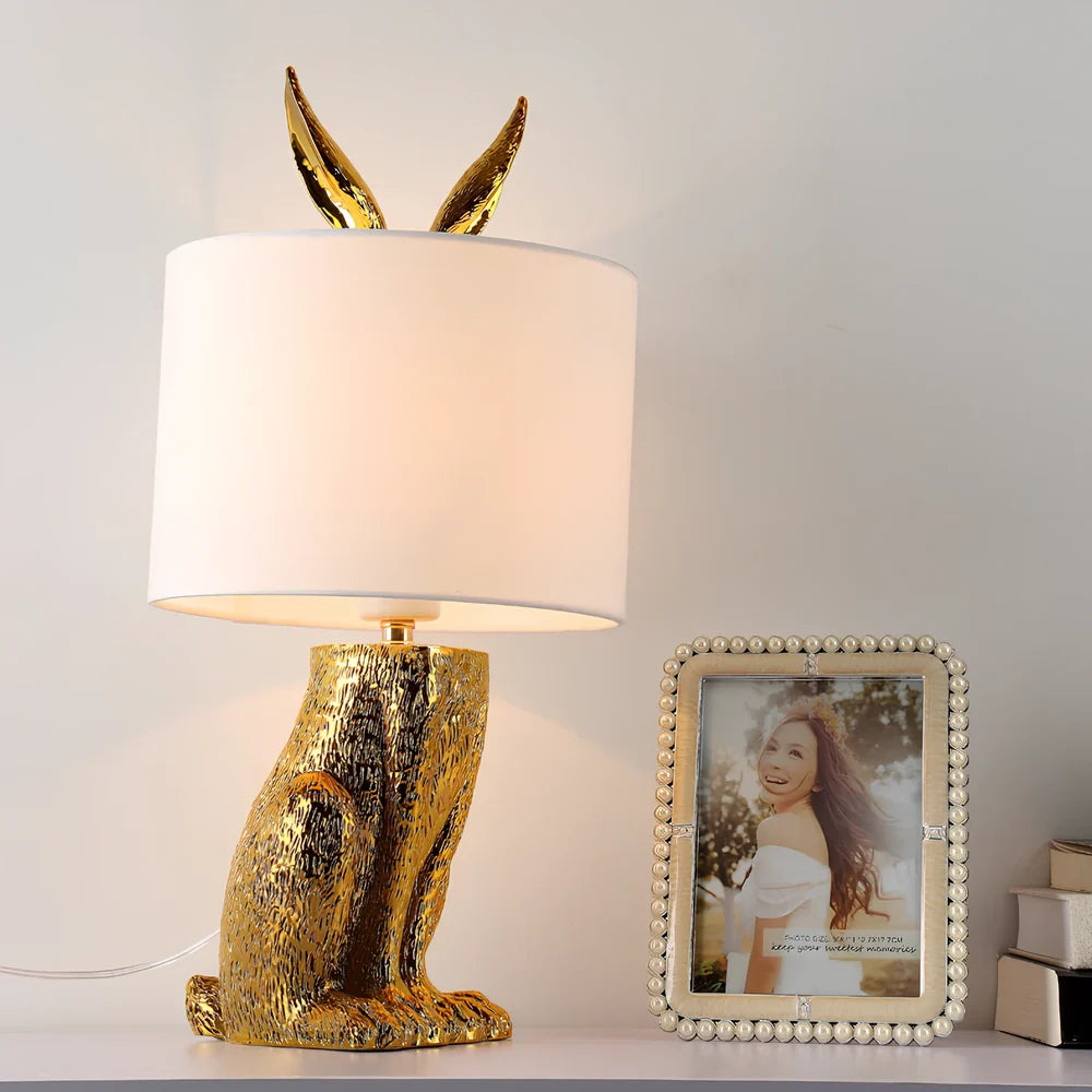 White rabbit table lamp with metal base and resin details, 24cm wide by 49cm high
