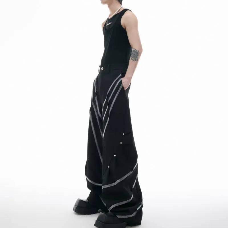 Men's trousers with three-dimensional cutting and metal striped rivet pleats in black or white, showing tailored fit and detail