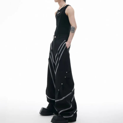 Men's trousers with three-dimensional cutting and metal striped rivet pleats in black or white, showing tailored fit and detail