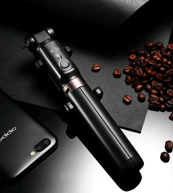 Black aluminium Bluetooth selfie stick with tripod legs extended, holding a smartphone.