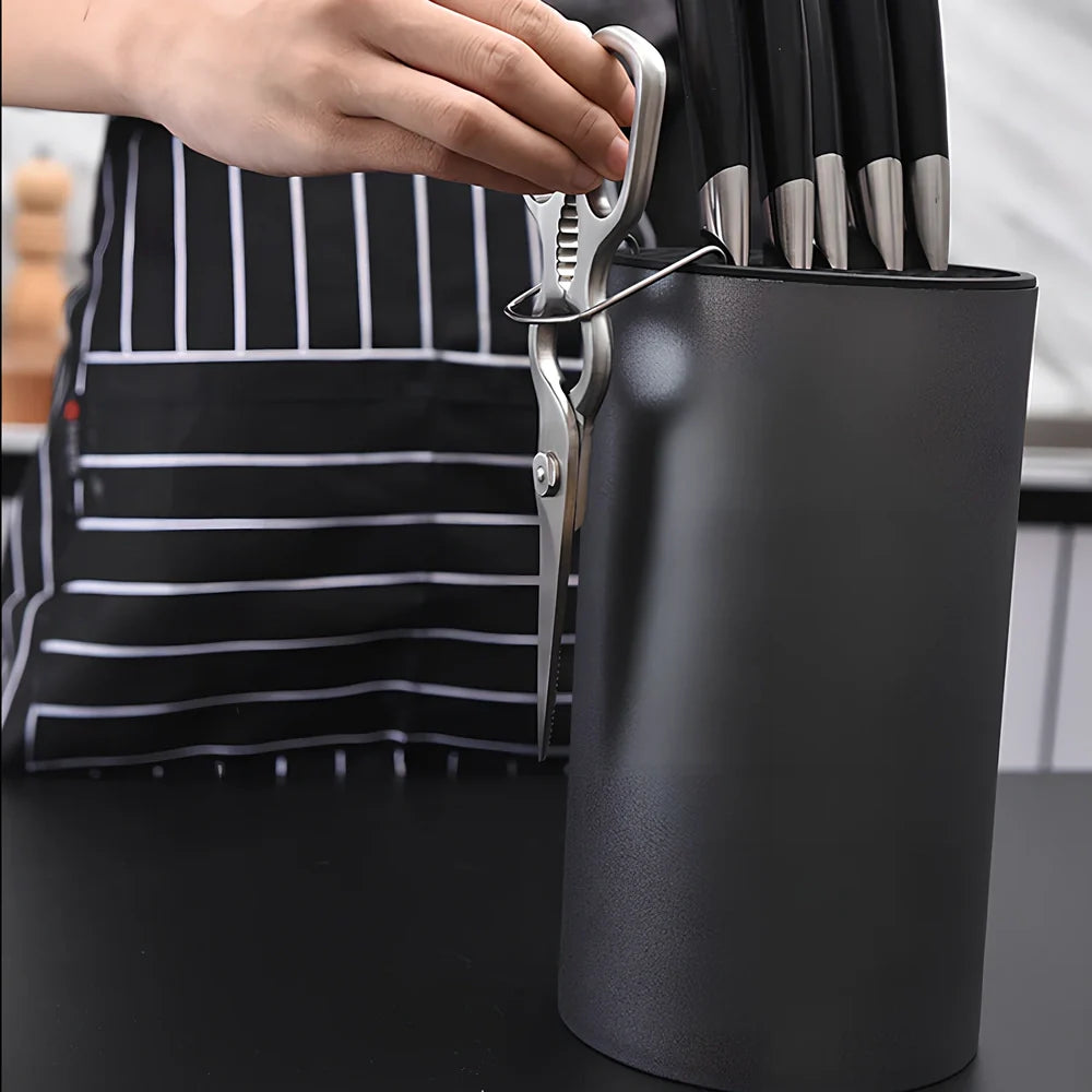 White wave pattern knife holder with integrated scissors hook storing multiple kitchen utensils