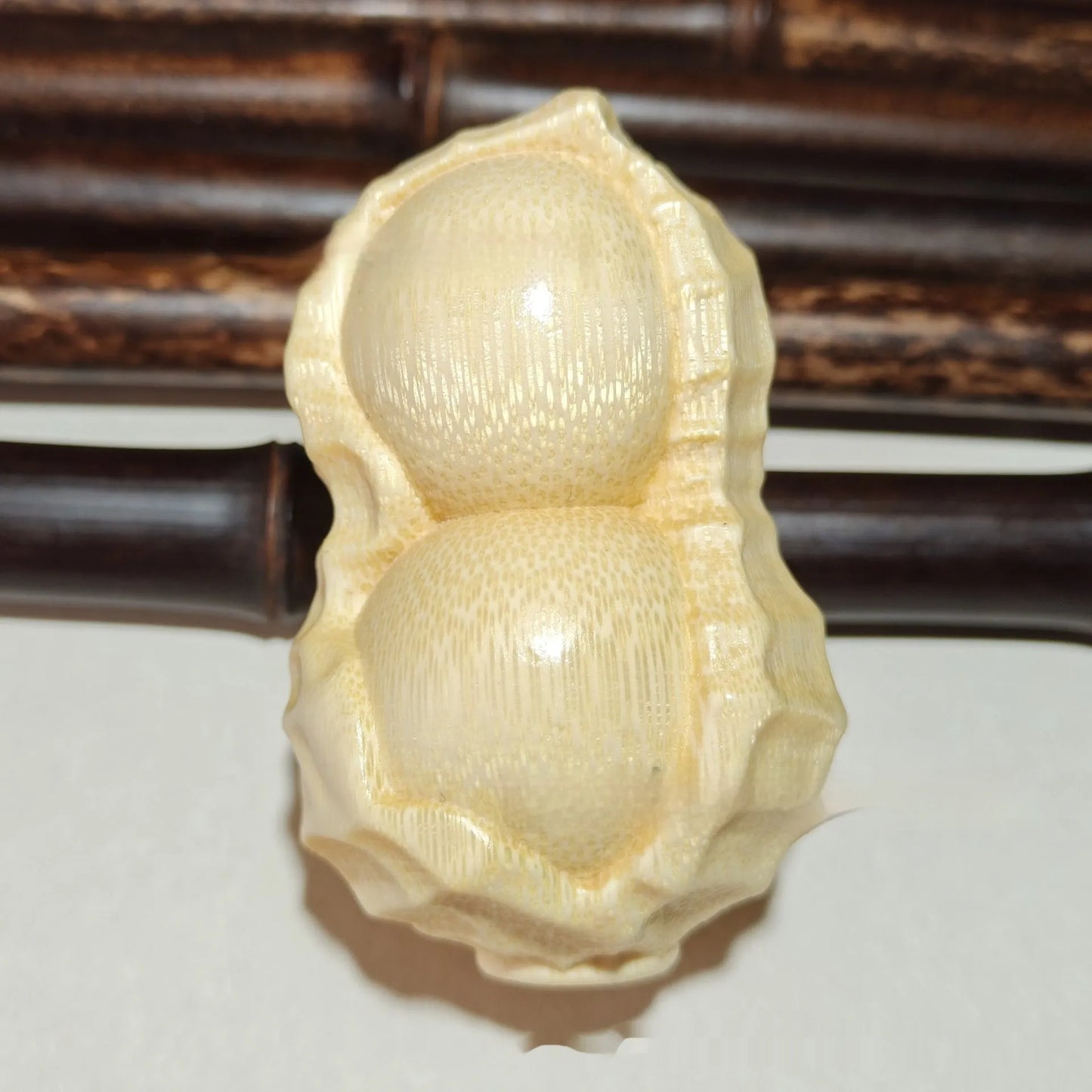 Hand-carved solid bamboo peanut ornament with modern design for gifting and decor
