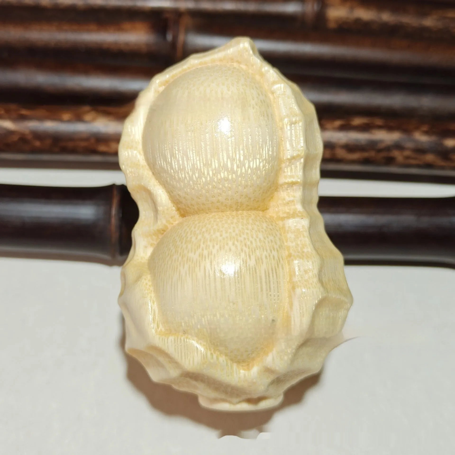 Hand-carved solid bamboo peanut ornament with modern design for gifting and decor