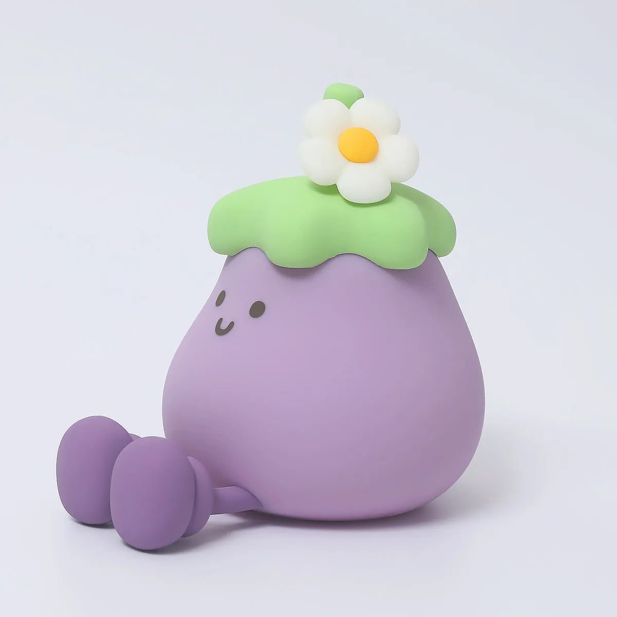 Cartoon eggplant shaped night lamp emitting soft yellow light, showing compact dimensions