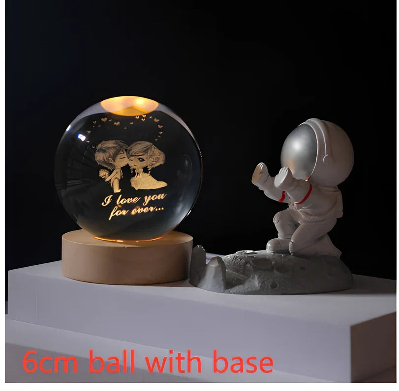 3D crystal ball night light projecting solar system pattern on wooden base with astronaut figurine