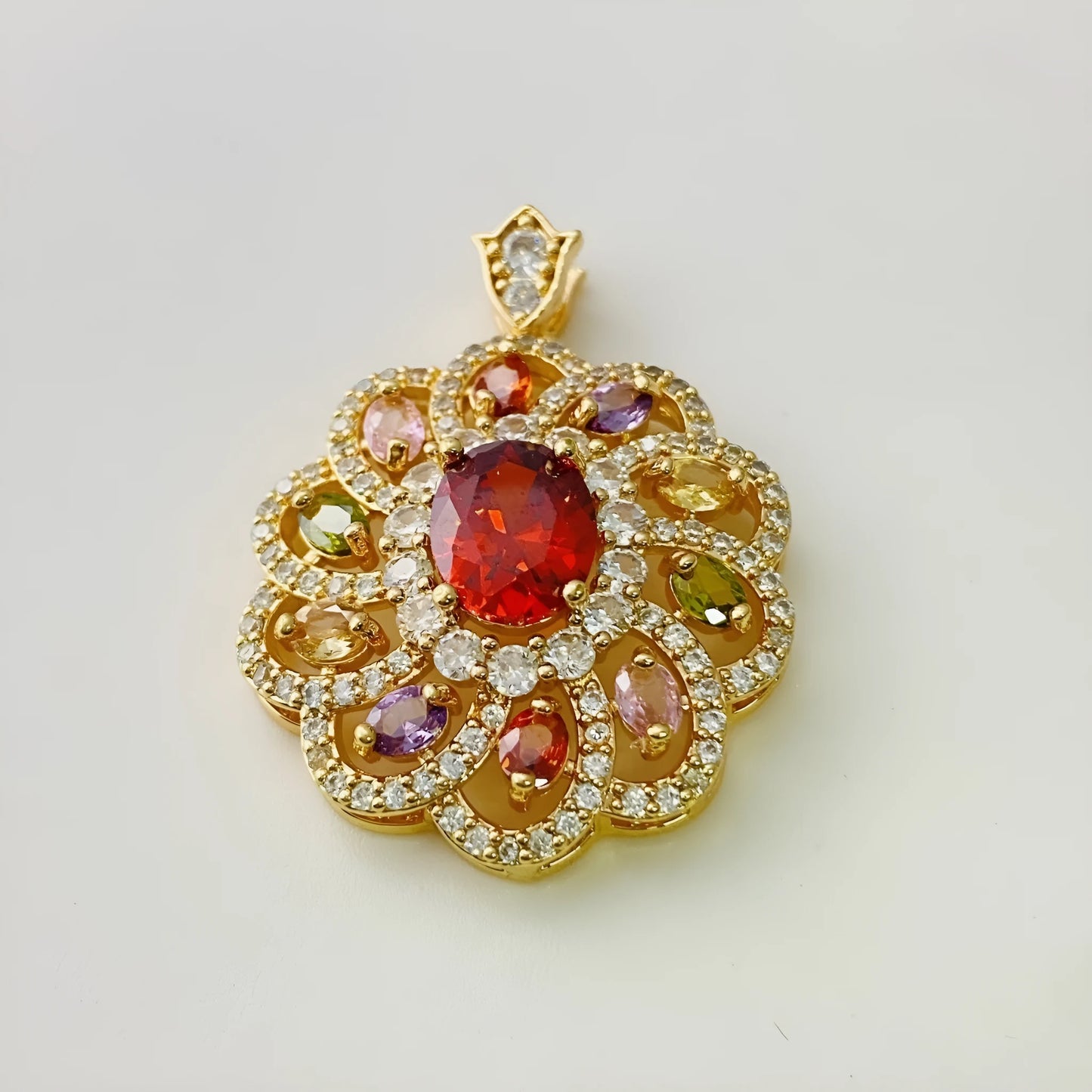 Close-up of a women's gold-coloured flower pendant necklace with a bright zircon stone centre.