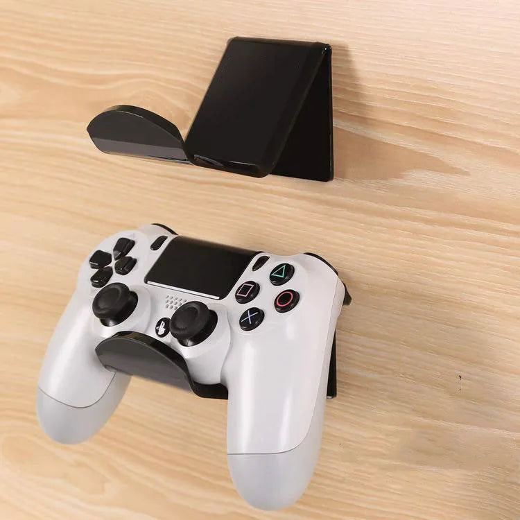 A universal black game controller mounting bracket shown installed on a wall.