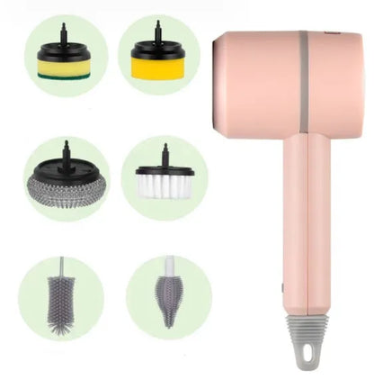 Green electric cleaning brush with scouring pad and brush heads on a kitchen worktop.