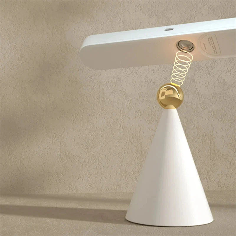 A modern, geometric desk lamp with wireless charging and a magnetic suction base for easy placement