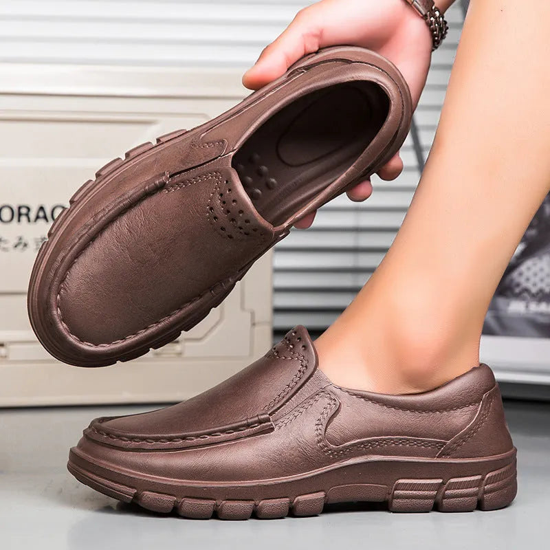 Men's black and brown slip-on work shoes with a mid-top, platform heel, and round toe.