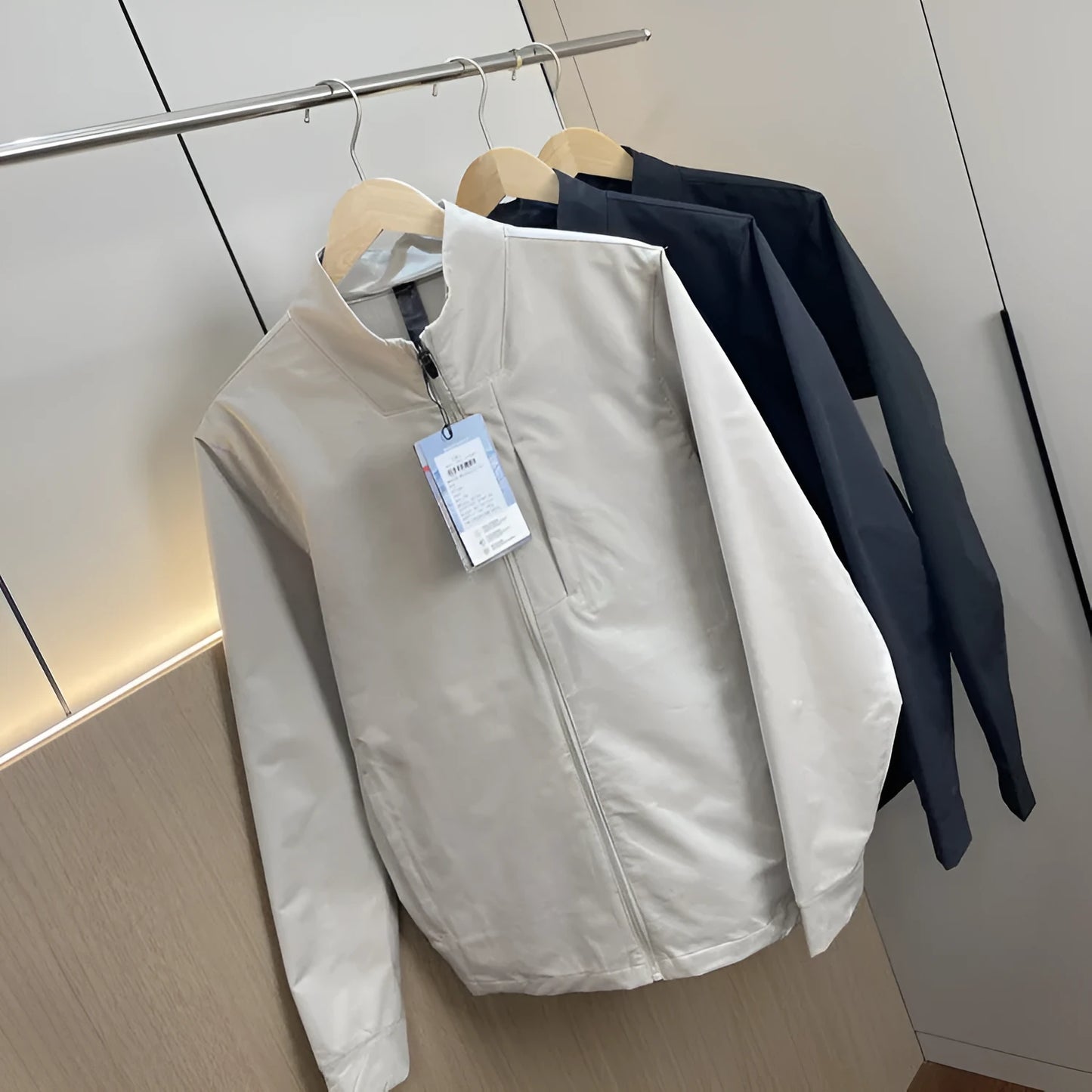 Men's stand collar casual jacket in polyester, shown in a neutral colour with straight hem and long sleeves.