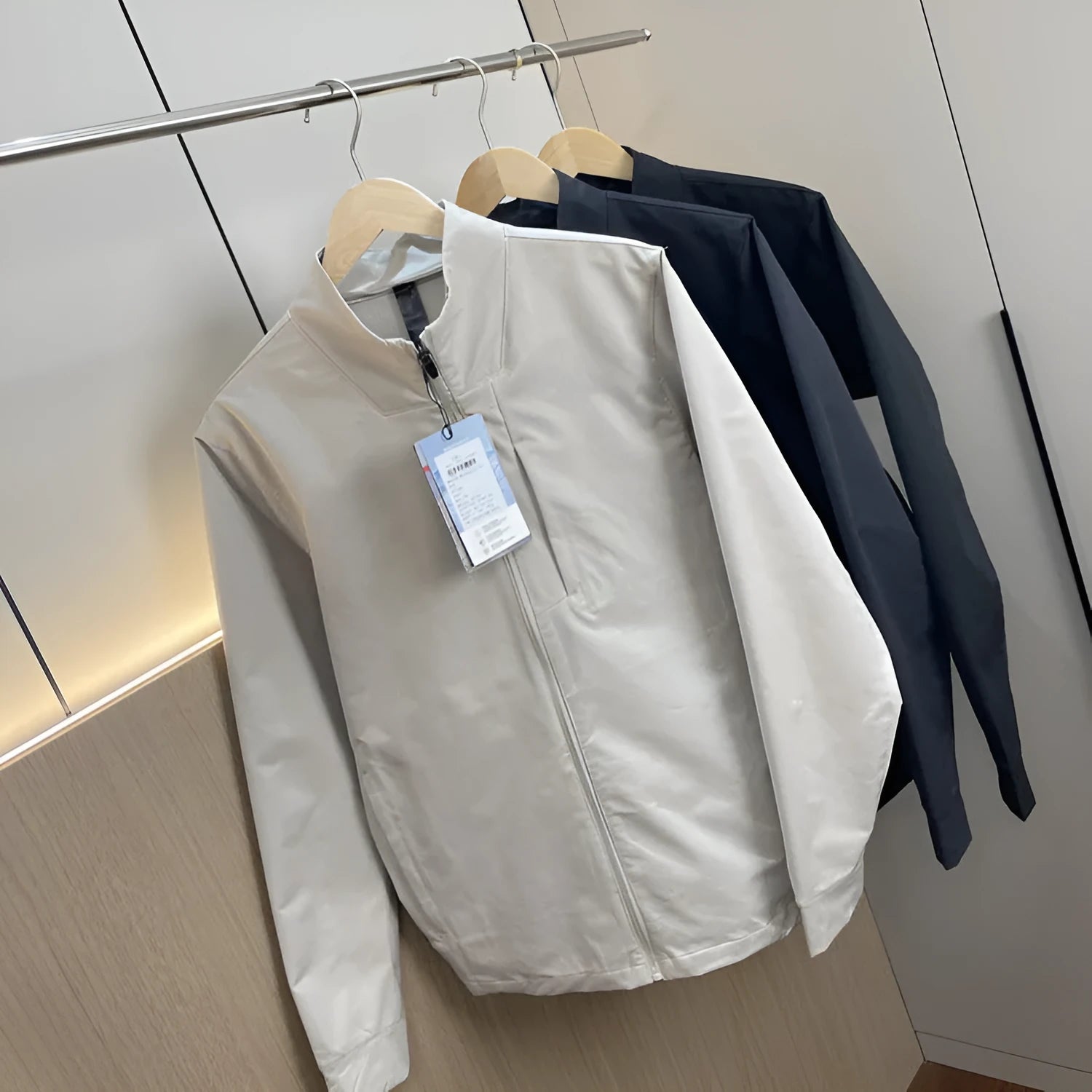 Men's stand collar casual jacket in polyester, shown in a neutral colour with straight hem and long sleeves.