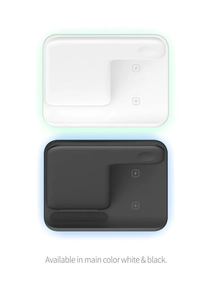 White three-in-one wireless charging stand for mobile phone, watch, and headphones on a desk.
