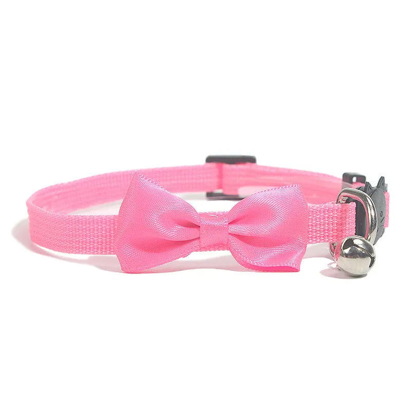 Striped nylon cat collar with decorative bow and bell in multiple colour options on a white background.