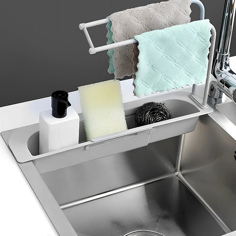 Blue telescopic sink rack holder with double-layer storage and drainage holes, mounted above kitchen sink