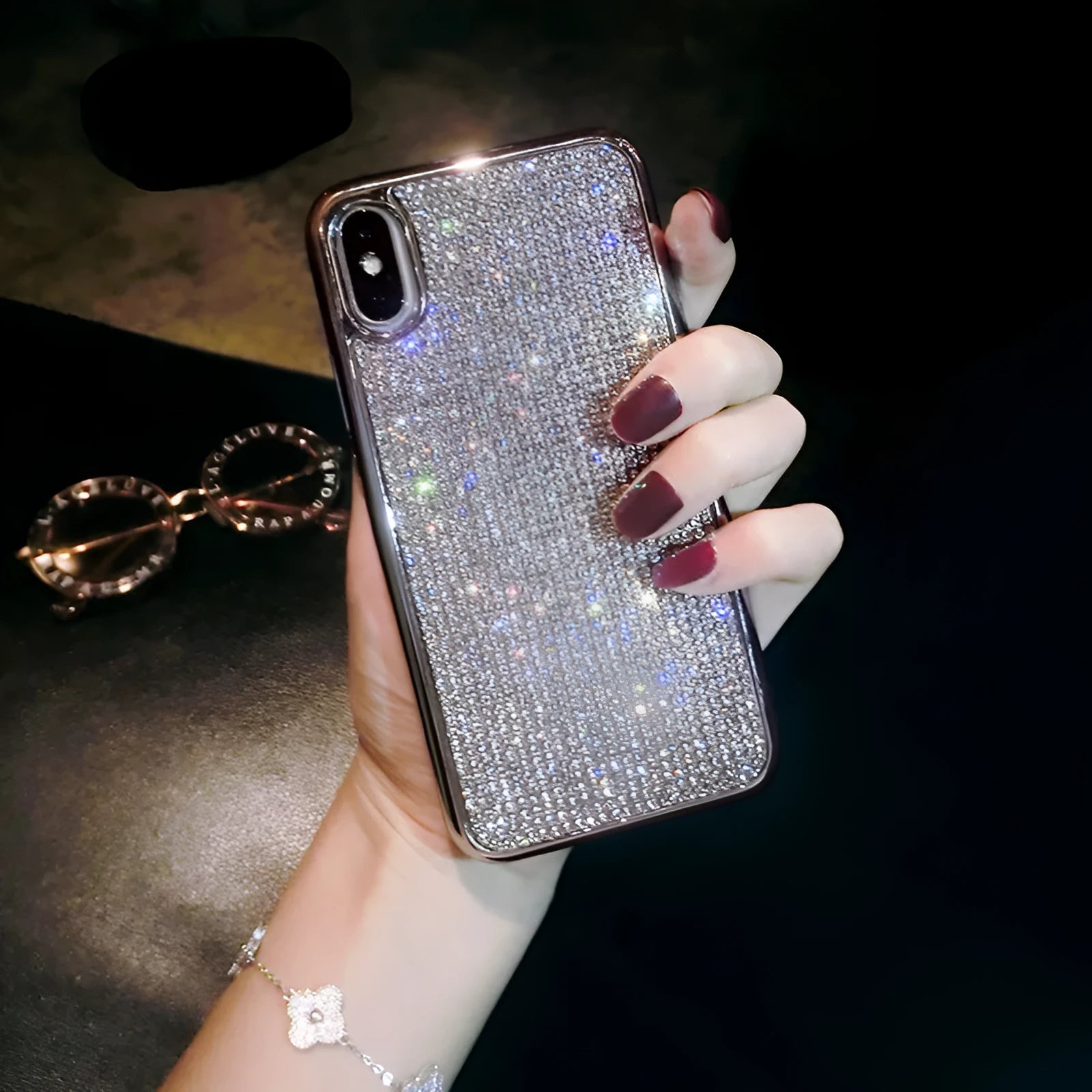 Silver silicone phone case with sparkling diamond decoration for various iPhone models.