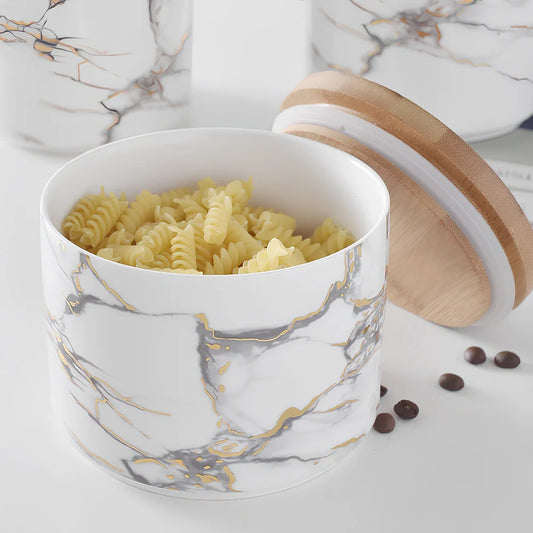 Three marbled ceramic storage jars with wooden lids showing large, medium, and small sizes