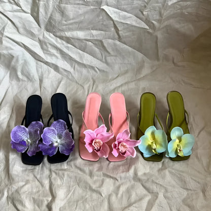 Pink women's flip-flop sandals with artificial Phalaenopsis orchid flower and square-toe design