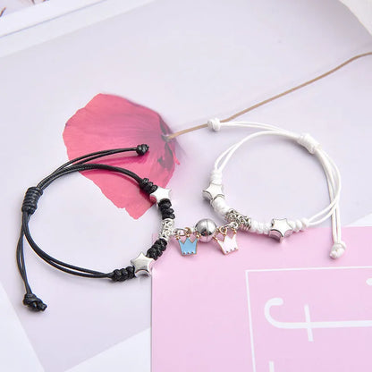 Magnetic suction couple bracelet pair in alloy with an electroplated finish, showing example designs like a crown and love lock.